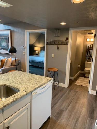 a kitchen with a sink and a living room at Breathtaking Mountain Views- Ski-in out 2BR Condo in Park City
