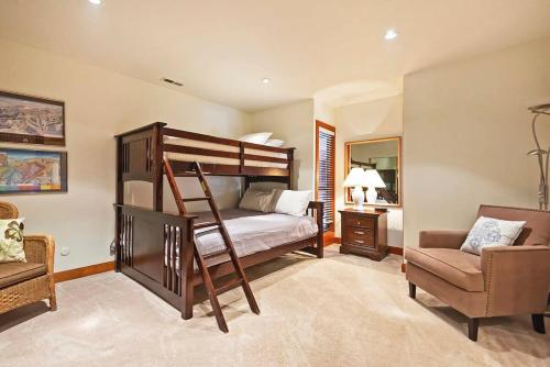 a bedroom with a bunk bed and a chair at Stunning Location 2BDR Condo Retreat in Park City