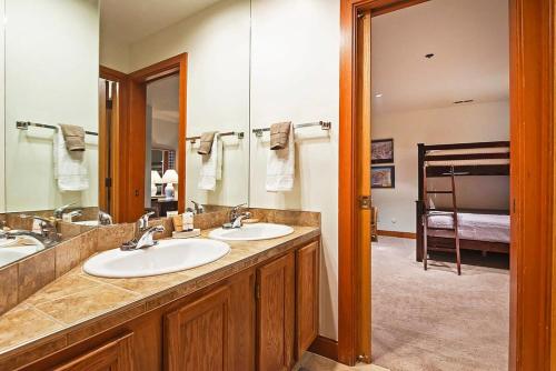 a bathroom with two sinks and a large mirror at Stunning Location 2BDR Condo Retreat in Park City