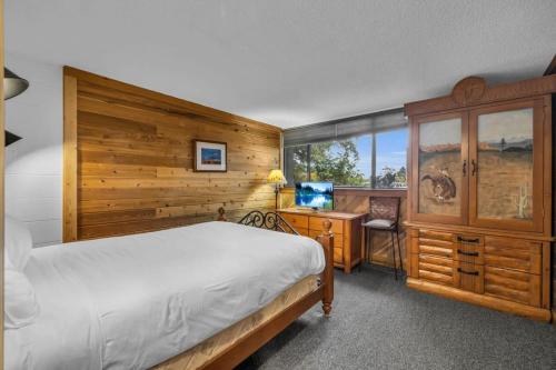 ein Schlafzimmer mit einem Bett und einem Schreibtisch mit einem Computer in der Unterkunft Centrally Located 1 BDR Condo Near Everything in Park City