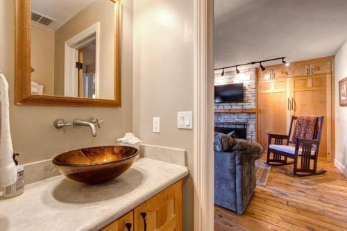a bathroom with a wooden bowl sink on a counter at Quaint 2BR Retreat Heart of Town Steps from Lift in Park City