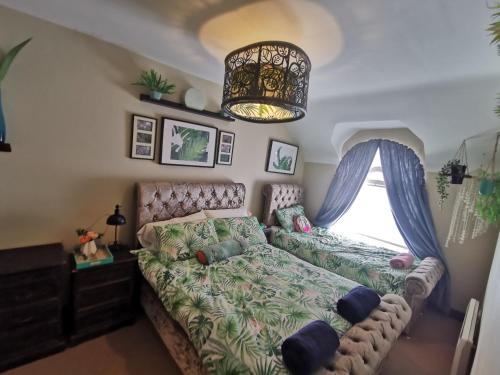 a bedroom with a couch and a window at Palm Cove Bundoran Luxurious Sea View Balcony Free Wifi Netflix Sleeps 5 in Bundoran