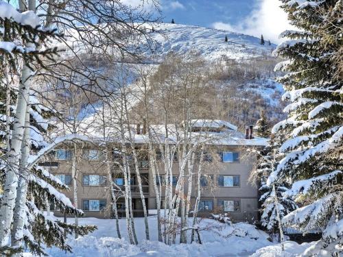a building on top of a snow covered mountain at Ski in out 2BDR Condo with Shared Hot Tub and Views in Park City