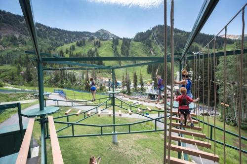 a group of people on a zip line in the mountains at Ski in out 2BDR Condo with Shared Hot Tub and Views in Park City