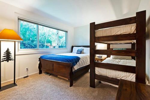 a bedroom with two bunk beds and a window at Ski in out 2 BDR Condo in the Heart of the Action in Park City