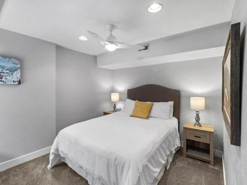 a bedroom with a white bed and two lamps at Park City Canyons Ski Cabriolet Community Amenity in Park City