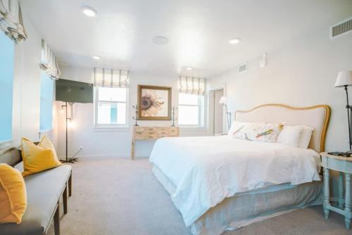 a white bedroom with a large bed and a couch at Amazing 3BR Condo on Main with Hot Tub Steps to Lift in Park City