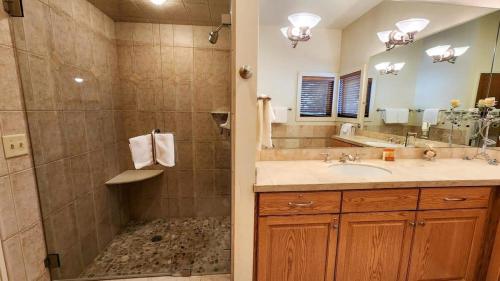 a bathroom with a shower and a sink and a mirror at 3BR Townhome Incredible Location in Park City