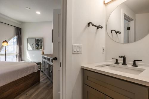 a bathroom with a sink and a bed and a mirror at Intimate 2BDR in Heart of Town Walk to Ski Lift in Park City
