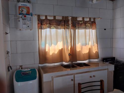 a small kitchen with a sink and a window at Estancia la juana in San Rafael