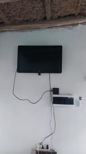 a flat screen tv hanging on a wall at Estancia la juana in San Rafael