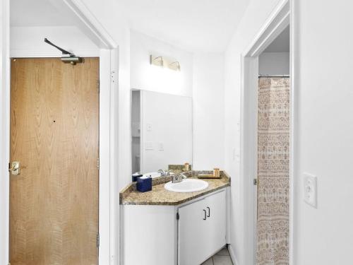 a white bathroom with a sink and a mirror at One BDR In Heart of Park City in Park City