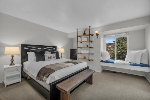 a bedroom with a large bed and a window at City Center 2BDR, Ski In - Close to Lift in Park City
