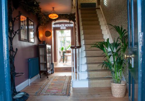 a hallway of a house with stairs and a door at The Dabbling Duck in Great Massingham