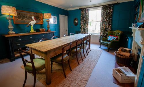 a dining room with a wooden table and chairs at The Dabbling Duck in Great Massingham