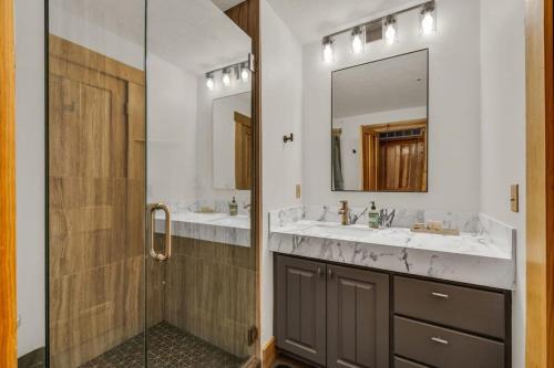 a bathroom with two sinks and a mirror at Luxurious 2BDR in Deer Valley with Hot Tub in Park City