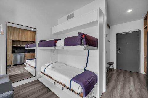 two bunk beds in a room with a kitchen at Chic Ski-in Ski-out Studio at Canyons Village in Park City