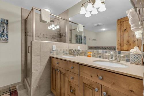 a bathroom with two sinks and a shower at Ski In Ski Out 3BR Steps from Ski Resort in Park City