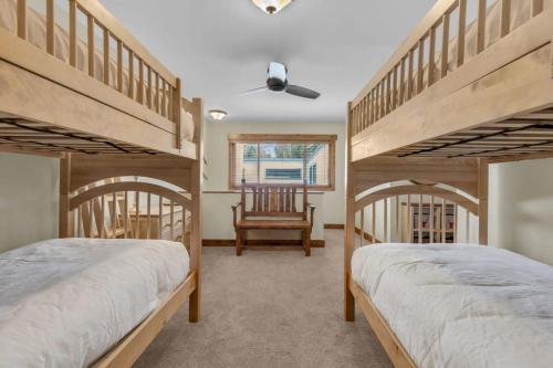 a bedroom with two bunk beds and a chair at Ski In Ski Out 3BR Steps from Ski Resort in Park City