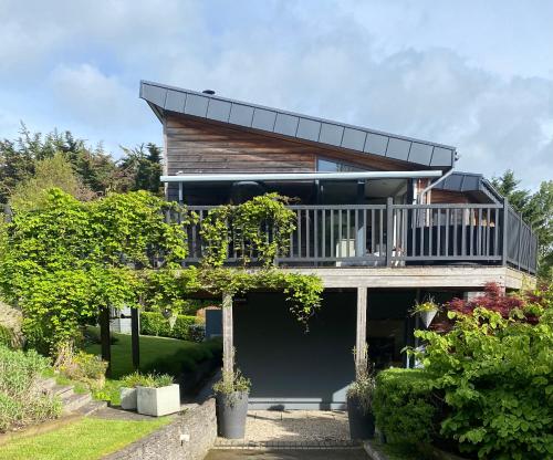 a house with a balcony on top of a yard at Luxurious villa south Dublin in Dublin