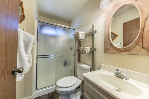 a bathroom with a toilet and a sink and a mirror at Tahoe Vista Retreat with Lake View Walk to beach in Tahoe Vista