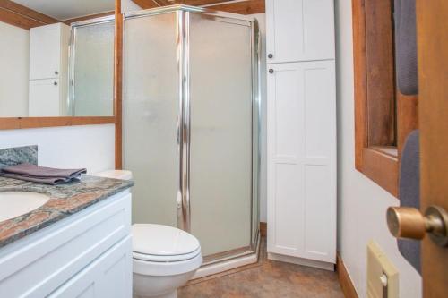 a bathroom with a toilet and a glass shower at One BDR at Northstar Walk to Village in Truckee
