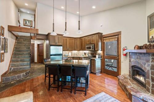 a kitchen with wooden cabinets and a fireplace at Northstar Ski in Ski out 2BR Condo in Truckee