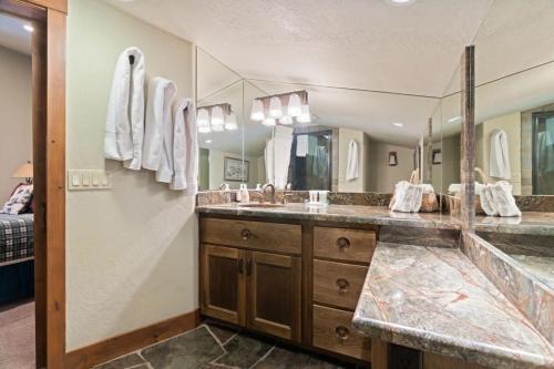 a bathroom with two sinks and a large mirror at Northstar Ski in Ski out 2BR Condo in Truckee