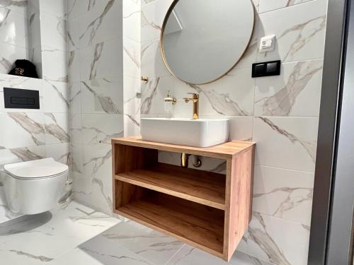 a bathroom with a sink and a mirror at SILVER BALTIC in Kołobrzeg