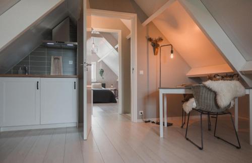a kitchen and dining room with an attic at B&B Landelijke Rust in Lutjewinkel