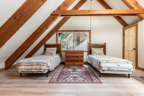 two beds and a rug in a attic at Brand New 3BDR Cabin 4 Min to Ski Resort and Beach in Tahoma