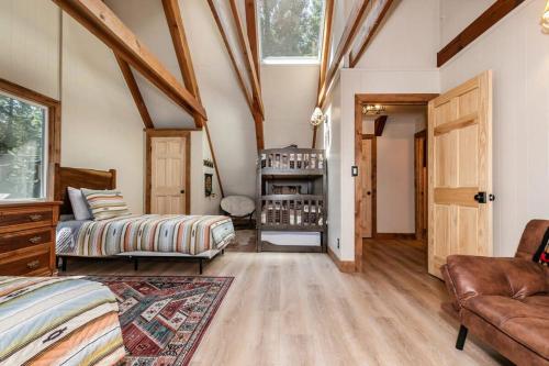 a bedroom with a bed and a couch and a window at Brand New 3BDR Cabin 4 Min to Ski Resort and Beach in Tahoma