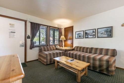 a living room with two couches and a table at Lakeside Studio Steps from the Beach in Tahoe Vista