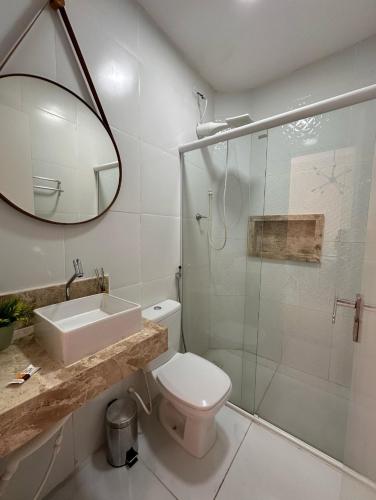 a bathroom with a toilet and a sink and a shower at DUNAS RESIDENCE CASA 14 in Santo Amaro