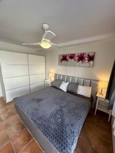 a bedroom with a bed and a ceiling fan at Granada I Apartment- Patalavaca in Patalavaca