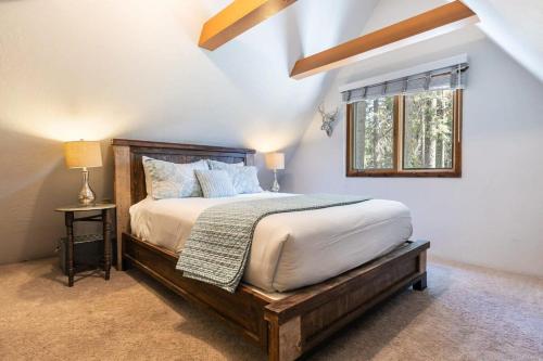 um quarto com uma cama com uma moldura de madeira e uma janela em Tahoe Dreamer Newly Remodeled 4BR em Carnelian Bay