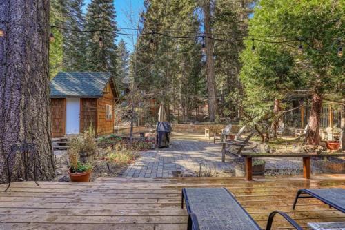 a wooden deck with benches and a tree at Serene 5BDR Near Beach and Forest Trails in Carnelian Bay