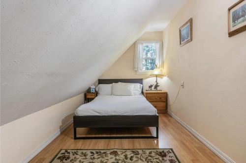 a bedroom with a bed and a staircase with a window at Serene 5BDR Near Beach and Forest Trails in Carnelian Bay