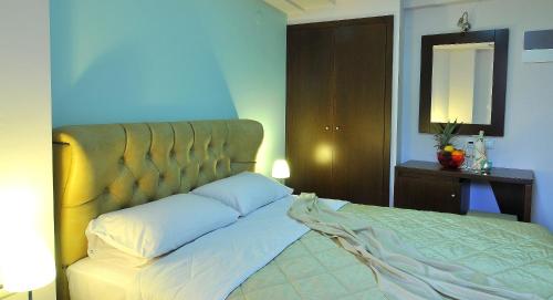 a bed with two pillows on it in a bedroom at Panorama Inn Hotel in Paralia Katerinis