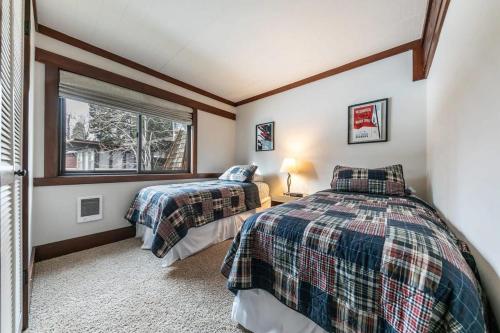 two beds in a room with a window at 4BD Lakeside Retreat with Views in Tahoe City