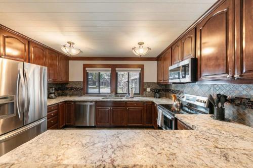 a kitchen with wooden cabinets and stainless steel appliances at 4BD Lakeside Retreat with Views in Tahoe City