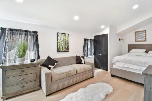 a living room with a couch and a bed at Stylish Downtown 2BD Walk to Chairlifts in Park City