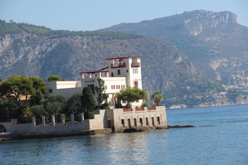 a house on a island in the middle of the water at Hôtel La Villa Patricia - Charme et Tradition in Villefranche-sur-Mer