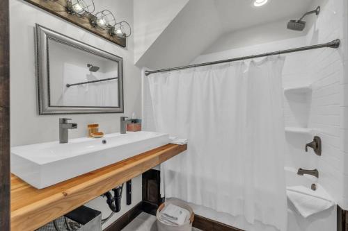 a bathroom with a white sink and a mirror at 2BD Near Slopes and Town with Impressive Views in Park City