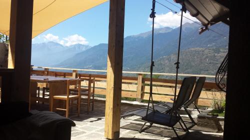 a view from a porch with a table and chairs at Appartamento Le Chalet in Albosaggia