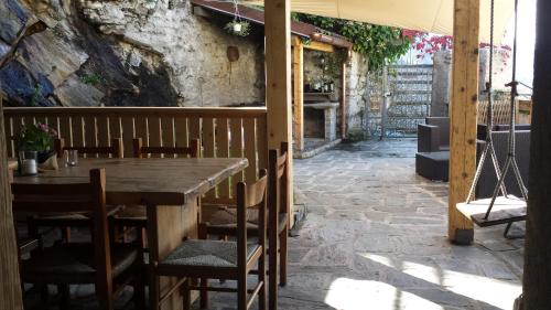 a wooden table and chairs on a patio at Appartamento Le Chalet in Albosaggia