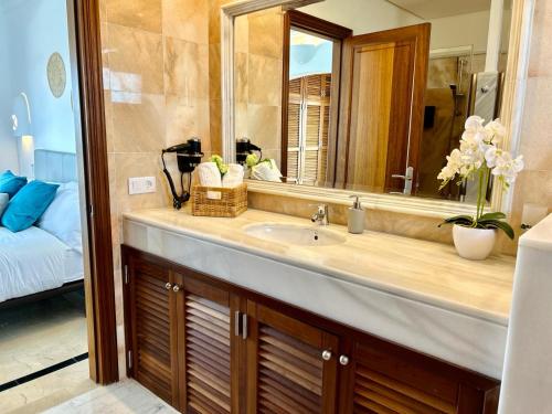 een badkamer met een wastafel en een spiegel bij Villa Sunset Zafiro in Playa Blanca