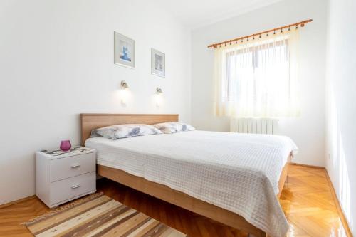 um quarto branco com uma cama e uma janela em Ferienwohnung für 4 Personen ca 55 qm in Njivice, Kvarner Bucht Krk - b44232 em Njivice