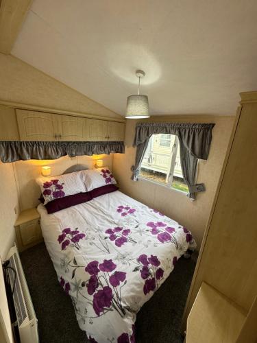 a bedroom with a bed in a small room at 8 berth Waterside Ingoldmells V8 Santanavan 3 in Skegness