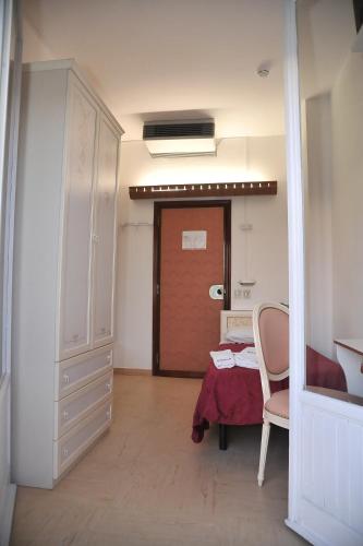 a room with a door and a table and a chair at Hotel Baia Marina in Cattolica